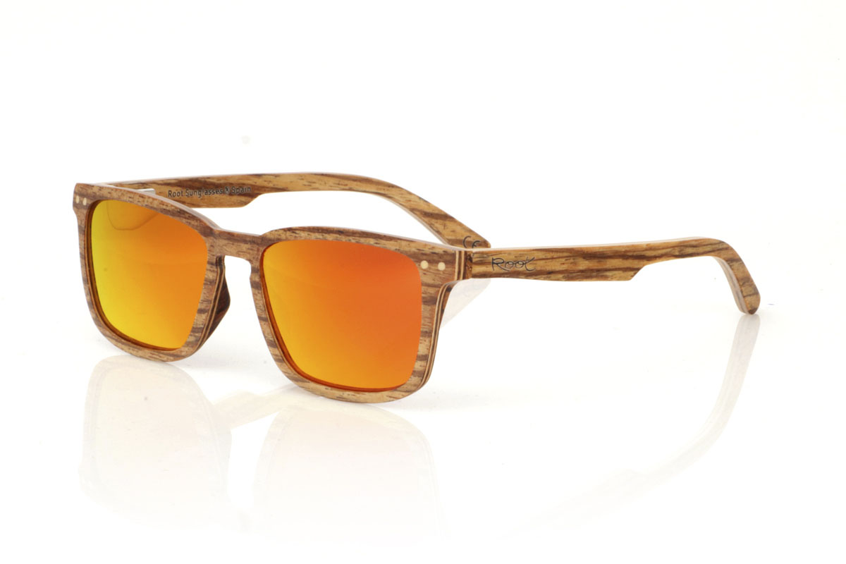 Wood eyewear of Zebrano modelo ROMUALD. ROMUALD wooden sunglasses stand out for their design, entirely made of light-colored laminated zebrawood with a marked grain, which gives them a distinctive and natural presence. Its more square shape adapts perfectly to smaller faces, offering a balanced and attractive aesthetic. Round maple wood inlays on the front add delicate detail. With measurements of 135x41 and a caliber of 50, these glasses are ideal for those looking for an accessory with personality and style. | Root Sunglasses® 